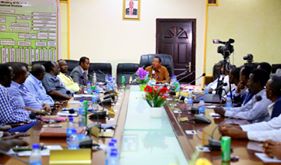 Image may contain: 2 people, people sitting, table and indoor