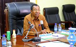 Image may contain: 1 person, smiling, sitting